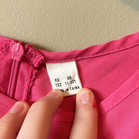 Pink romper and a zipper back and string that you can tie and untie. - Picture 2 of 2